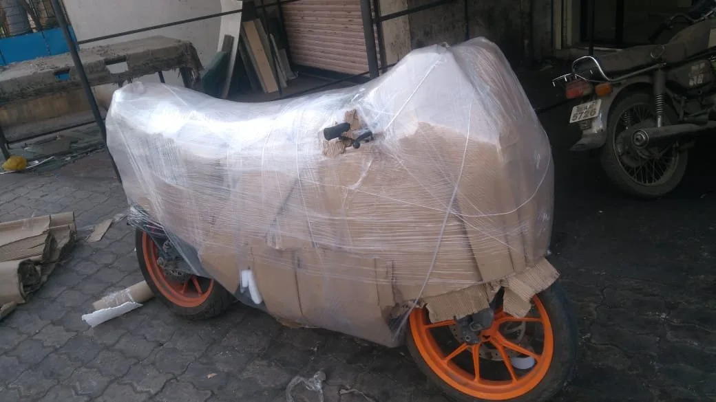 Motorcycle fully wrapped in foam and stretch film before transport