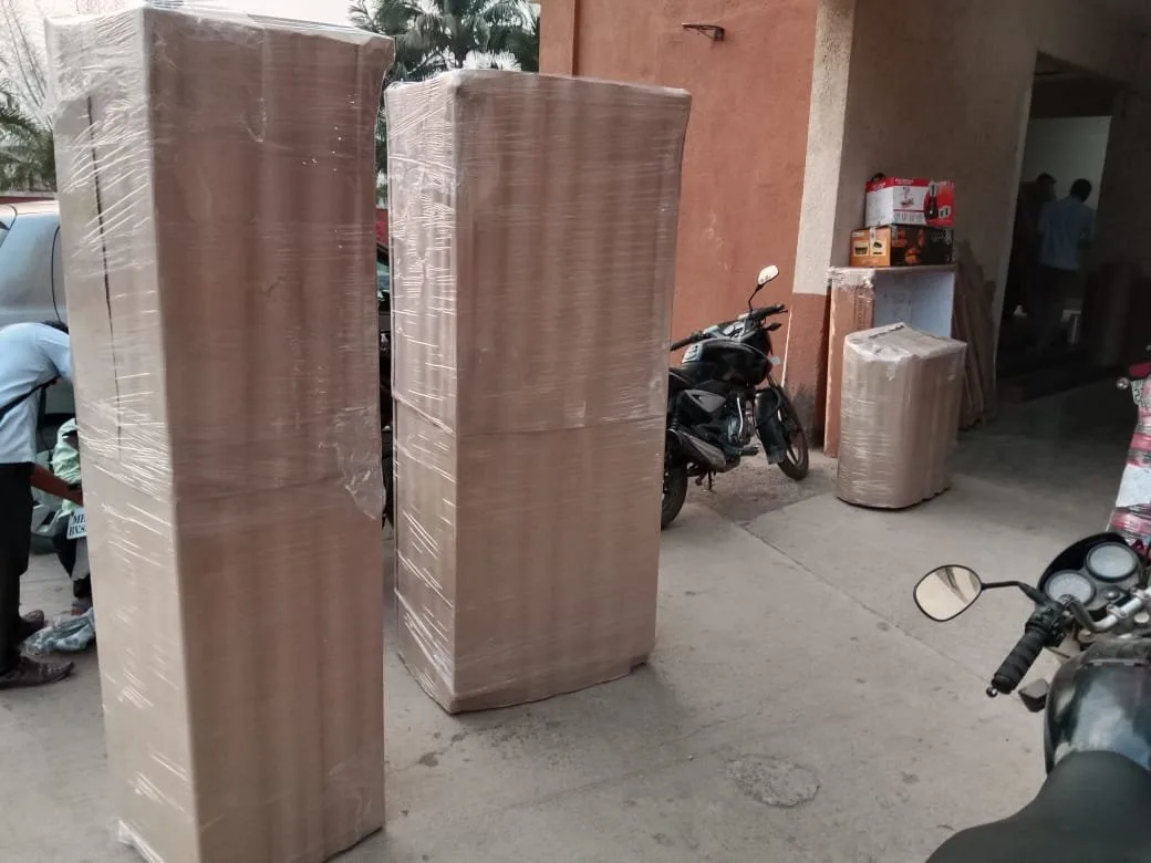 Two wardrobes wrapped in corrugated sheet and film